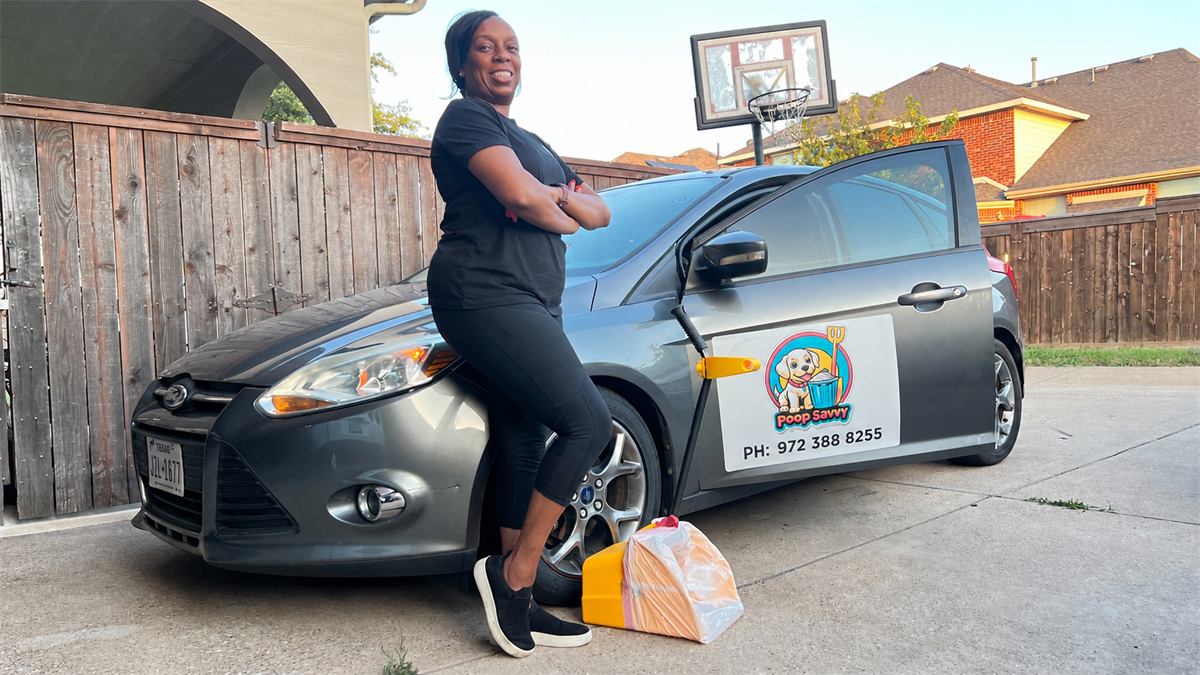 Poop Savvy co-owner standing beside a branded gray service car